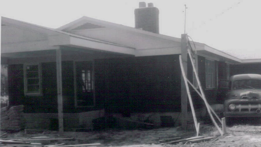 The front entrance and roof framing under construction at the parsonage.