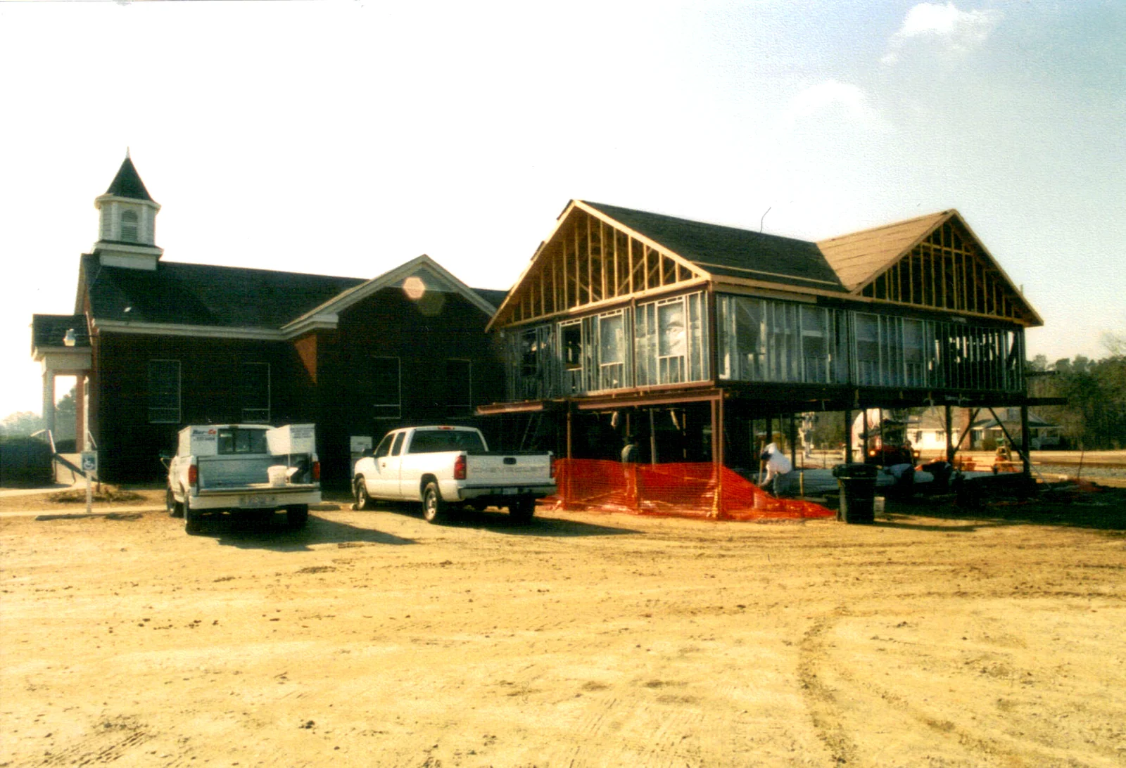 The framework of the new fellowship hall rising beside the sanctuary.