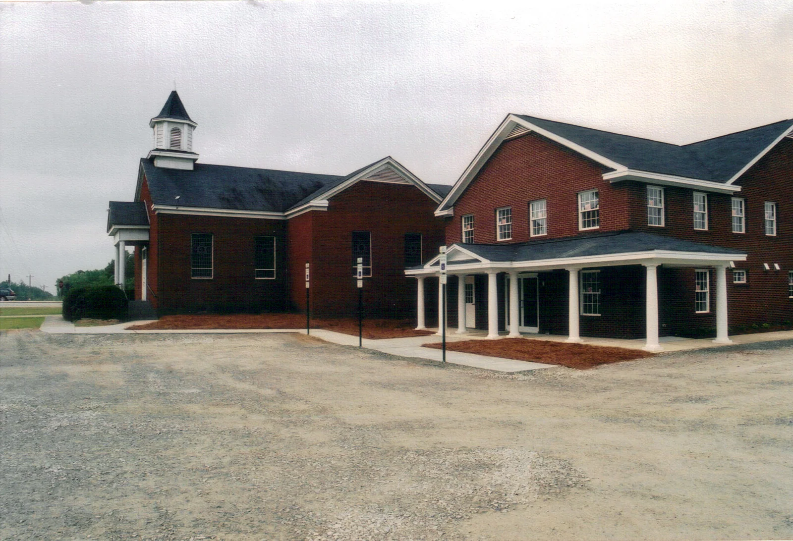 The completed two-story church addition beside the historic sanctuary.