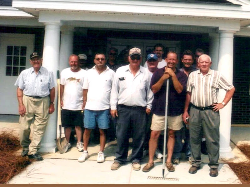 The volunteer crew gathered in front of the completed church addition.