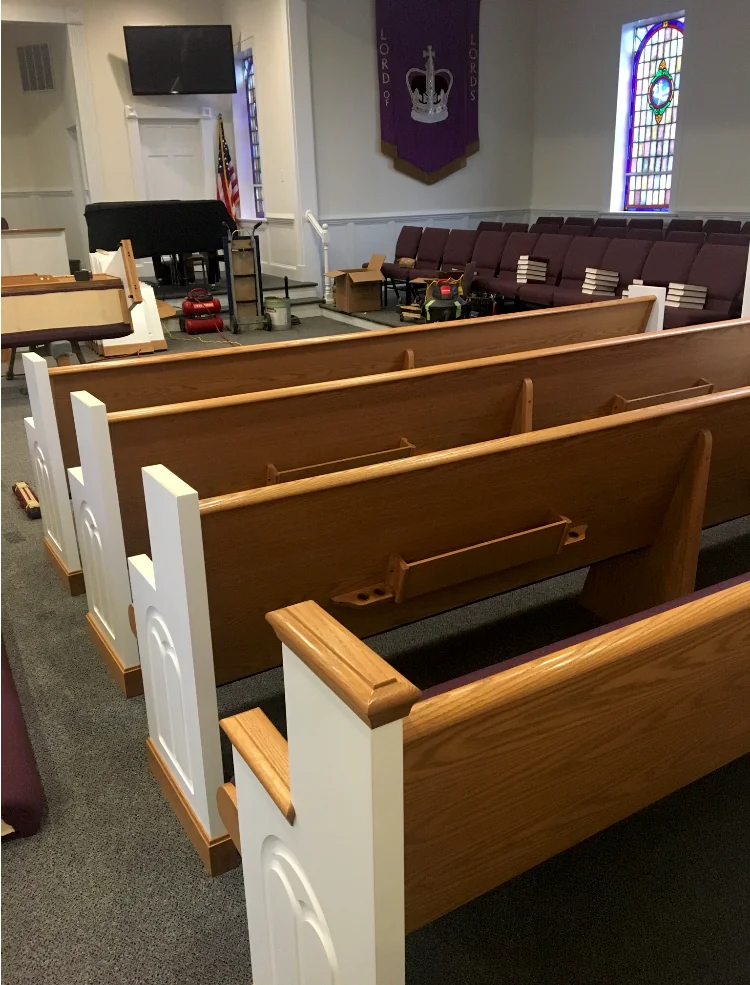 New pew installation in progress in the sanctuary.