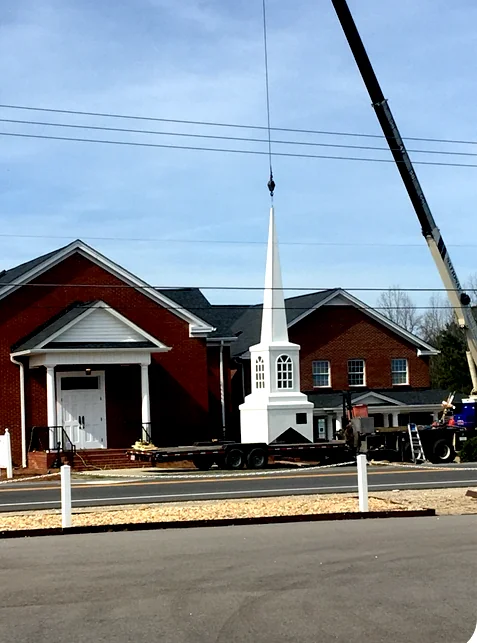 The new church steeple arriving for installation.