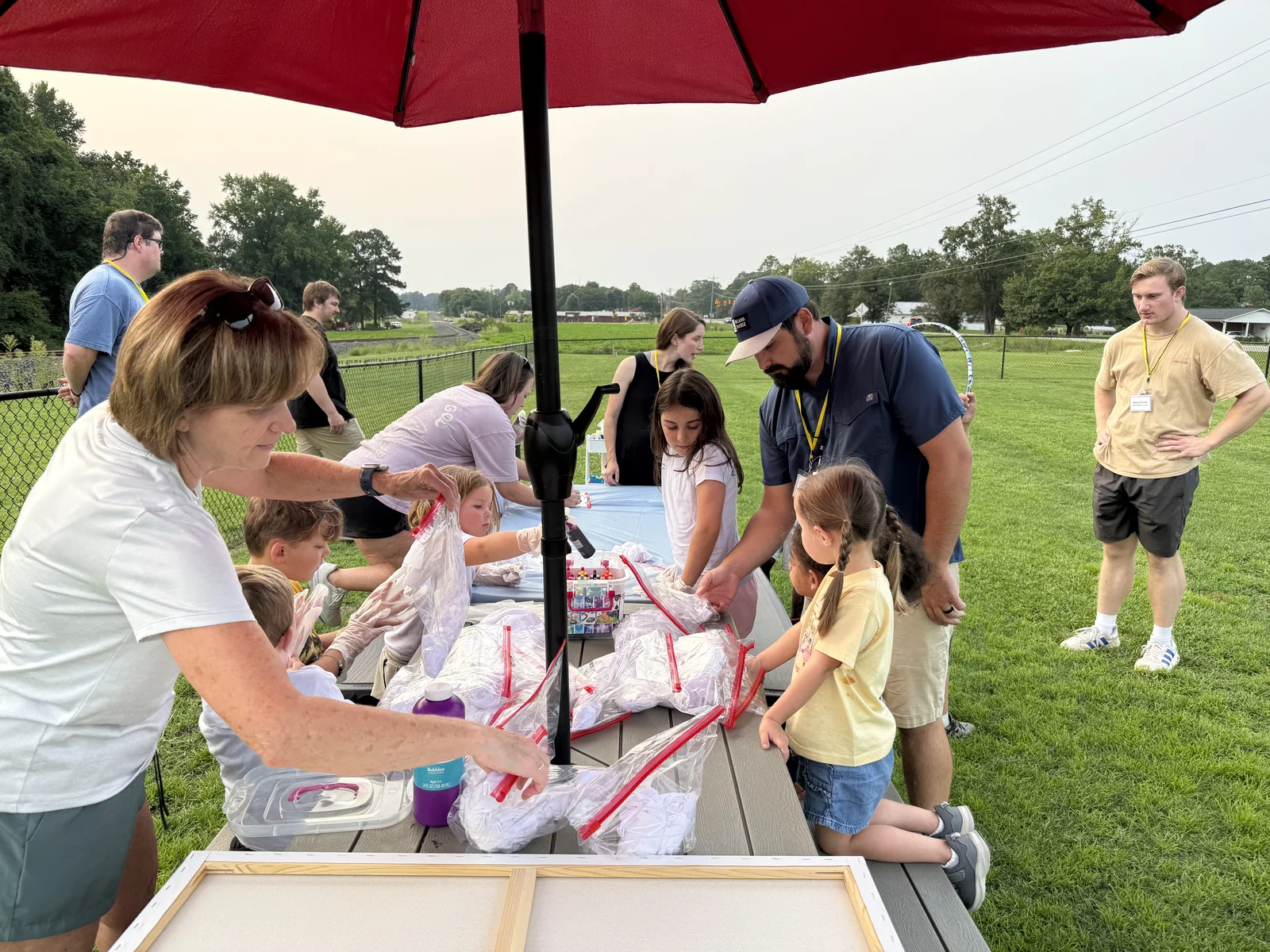 Children and volunteers working on an outdoor craft during Backyard Bible Club.