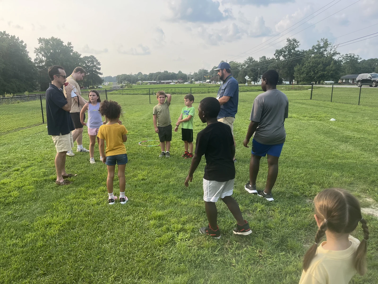 Children and volunteers participating in outdoor games during Backyard Bible Club.