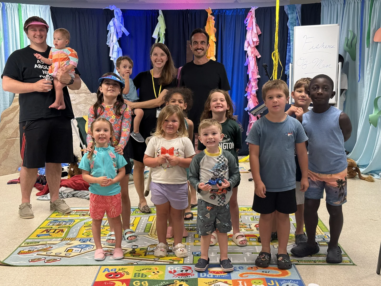 Children and volunteers gathered for a group photo during Backyard Bible Club.