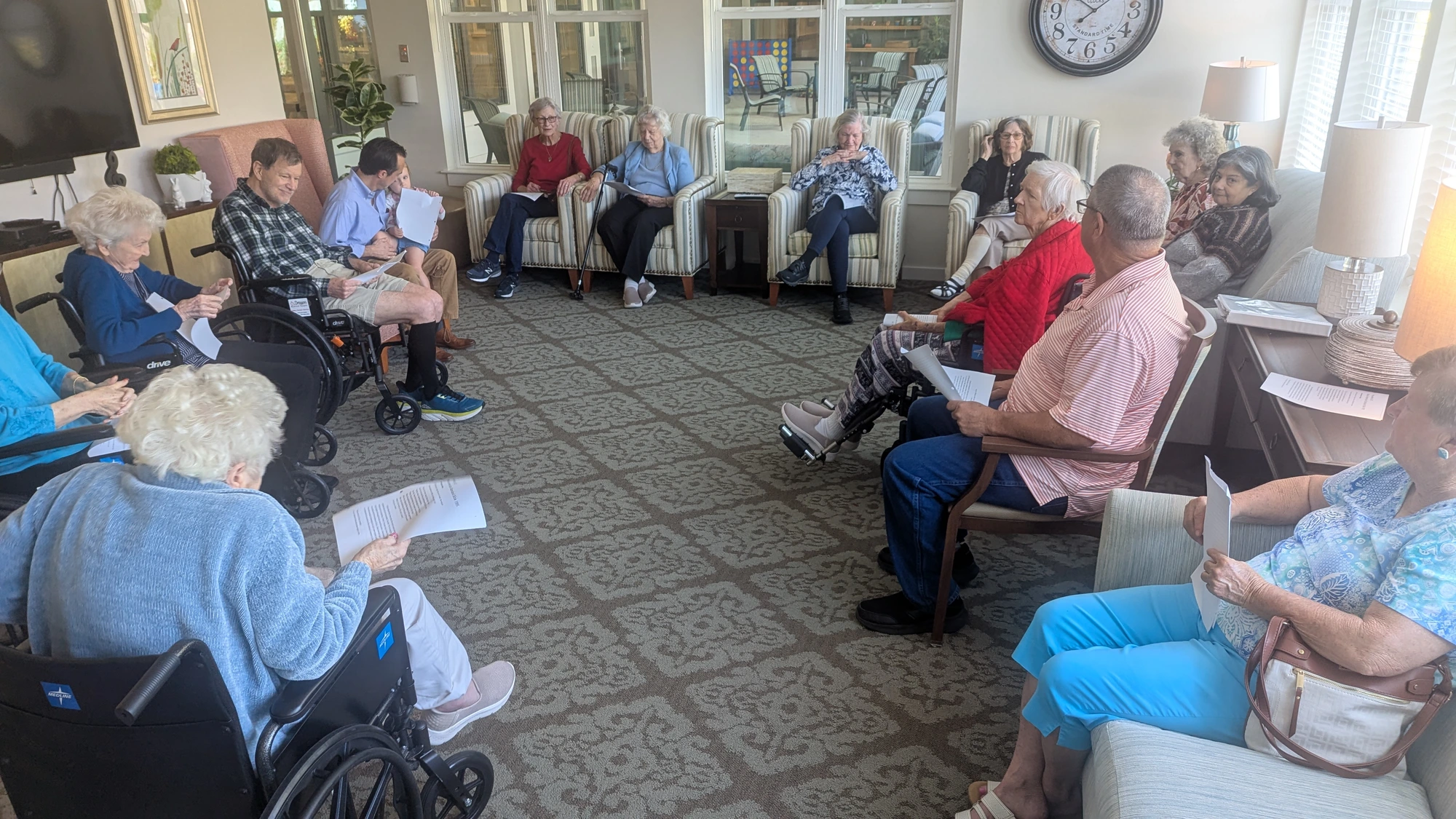 Adults gathered in a circle for Bible study at Calyx Senior Living.