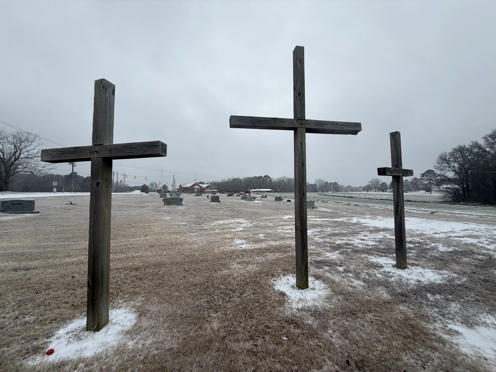 Three crosses overlooking the Rawls Baptist Church Cemetery after snowfall.