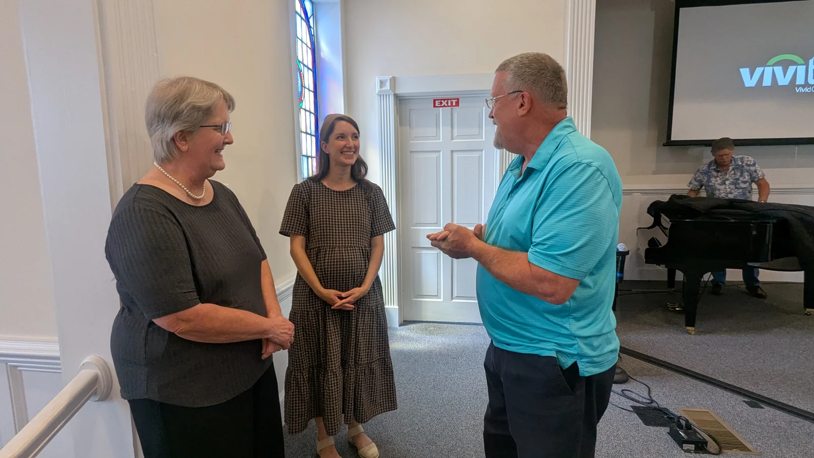 Members of Rawls Baptist Church visiting together in the sanctuary.