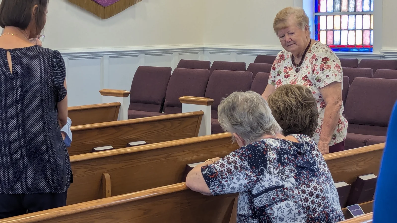 Members of Rawls Baptist Church visiting together among the sanctuary pews.