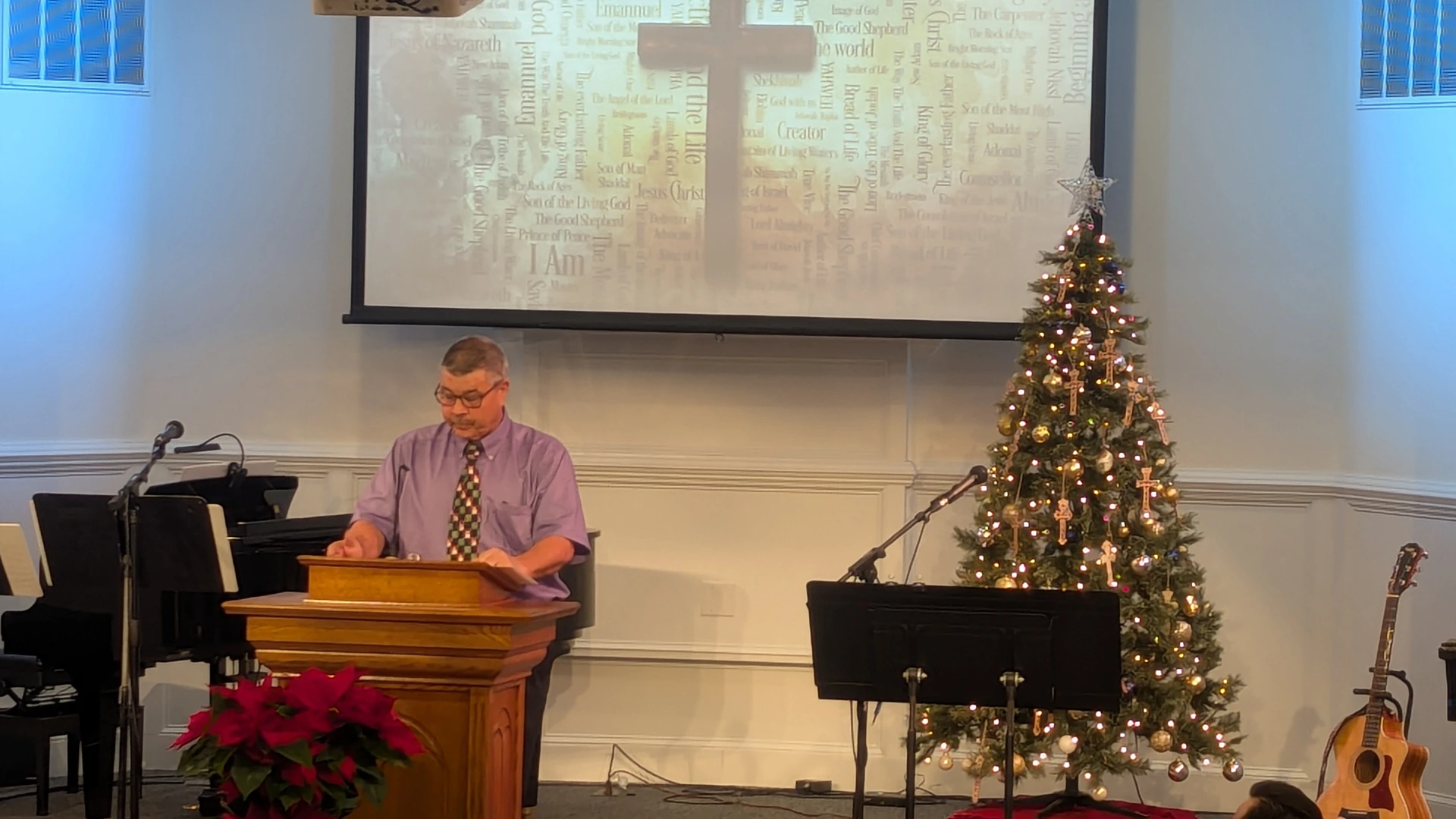 Donnie preaching from the pulpit beside the Christmas tree during a Christmas service at Rawls Baptist Church.