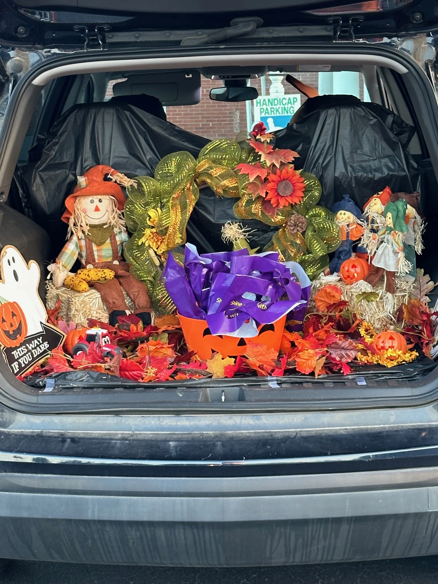 Fall themed decorated trunk with pumpkins and seasonal decorations at Family Fall Fest.