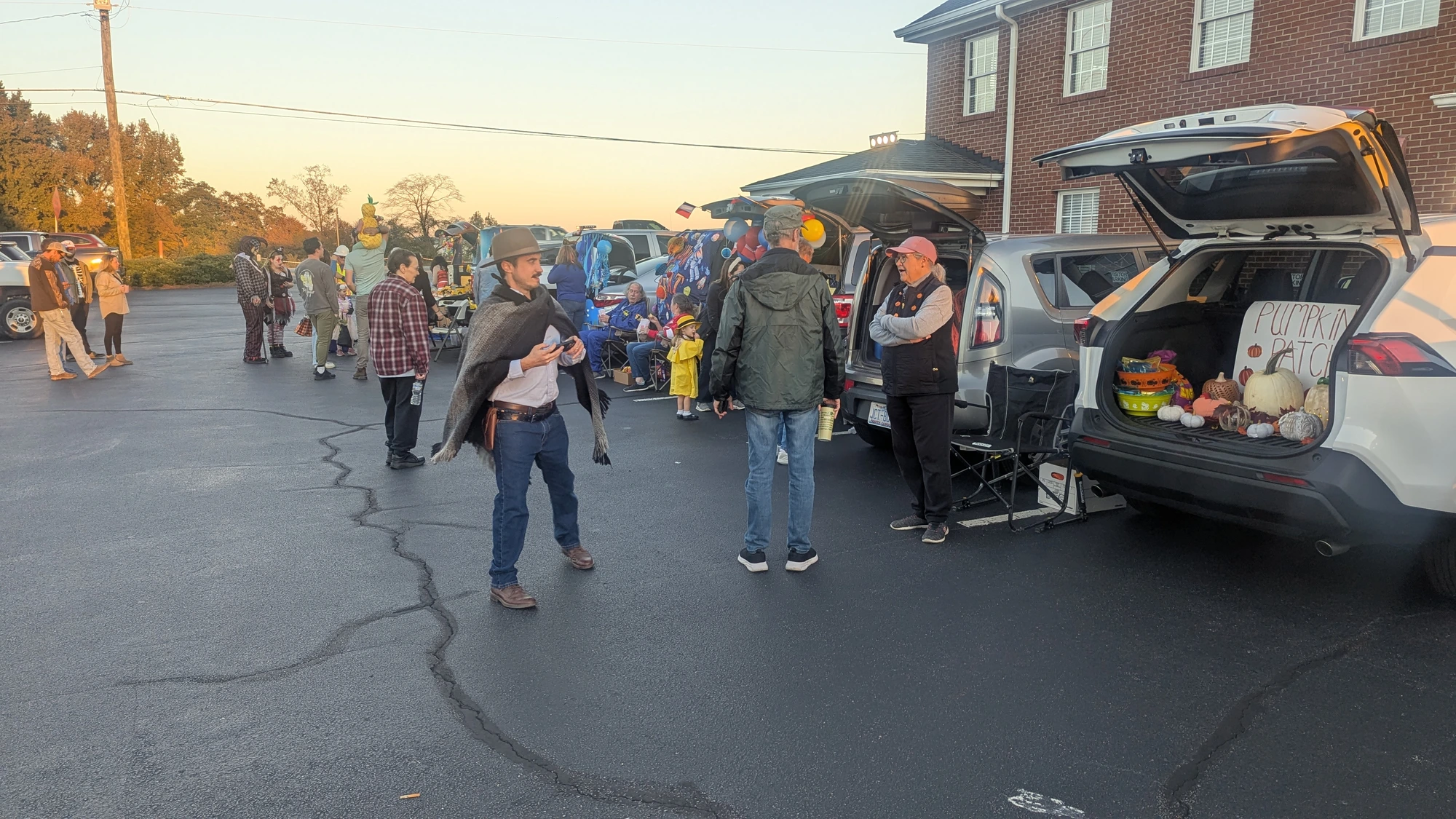 Pastor Brandon and visitors among decorated trunks during Trunk or Treat at Rawls Baptist Church.