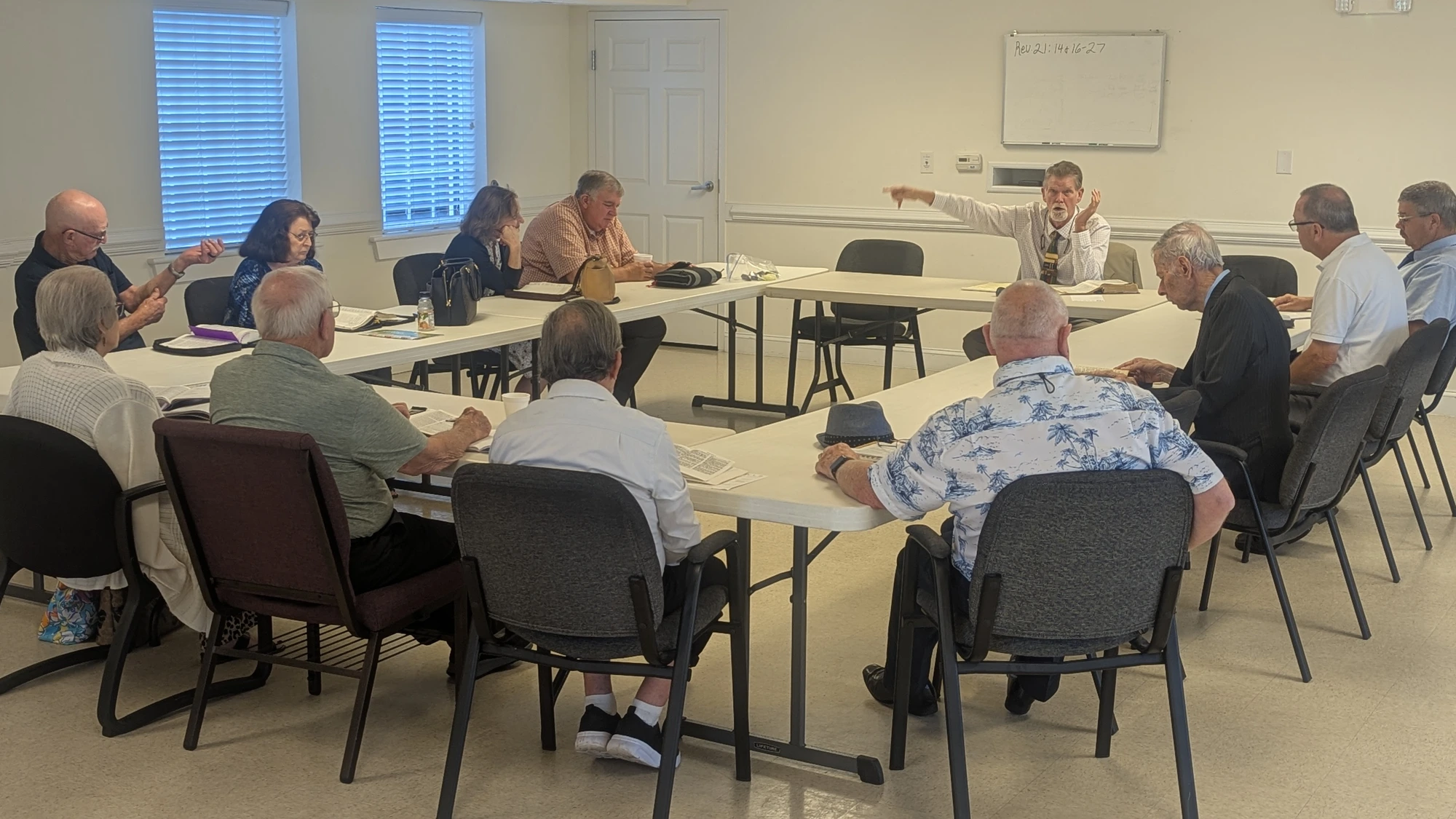 Men and couples gathered around tables for Sunday School at Rawls Baptist Church.
