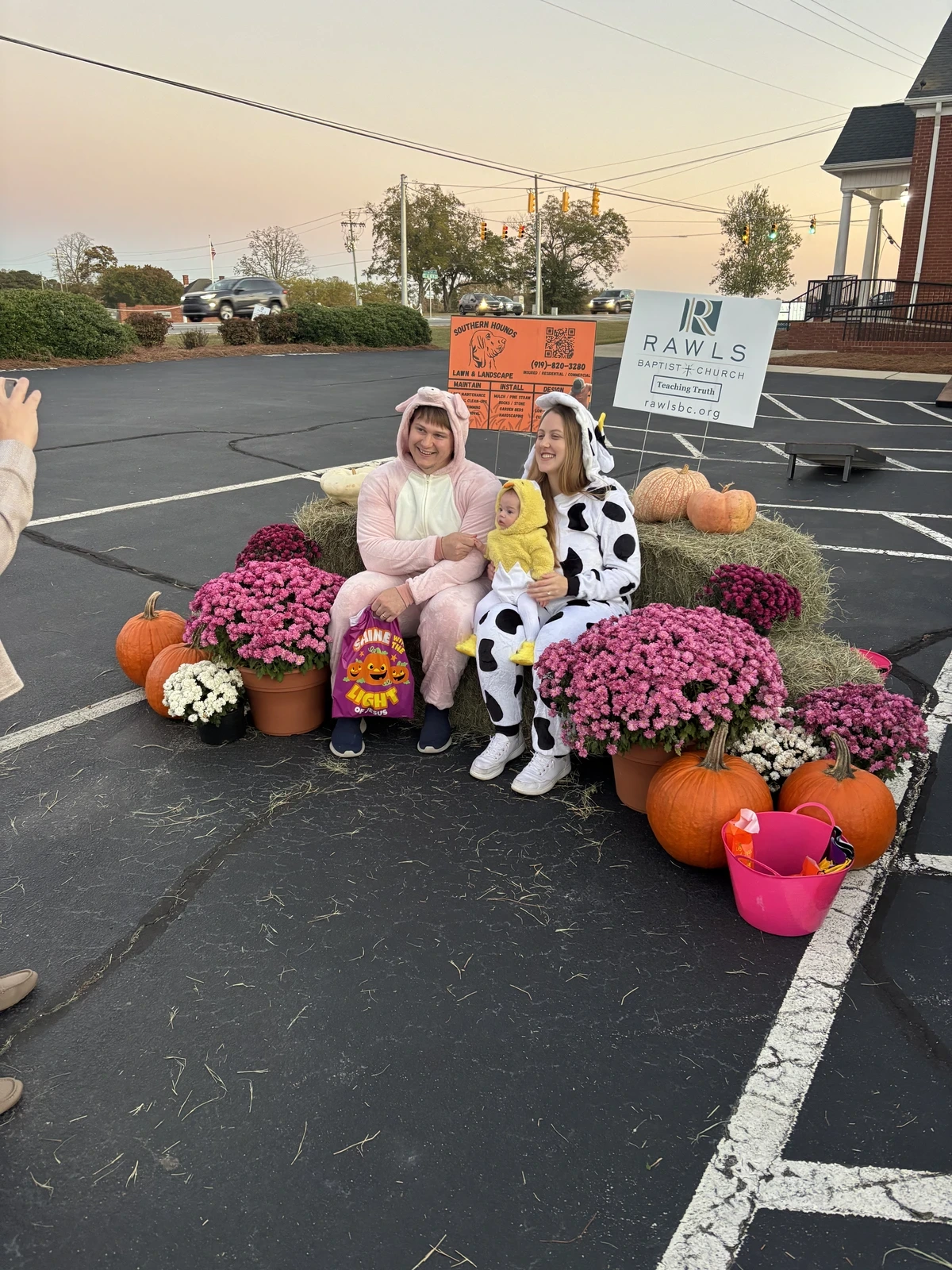 Children in costumes posing among pumpkins and fall decorations at Family Fall Fest.