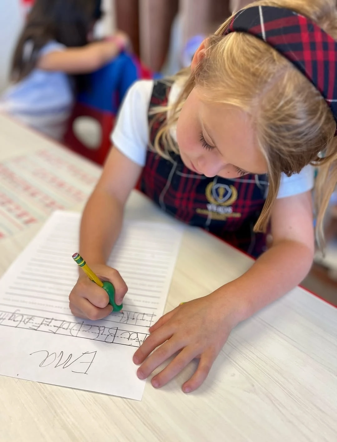 Velos student practicing handwriting during class.