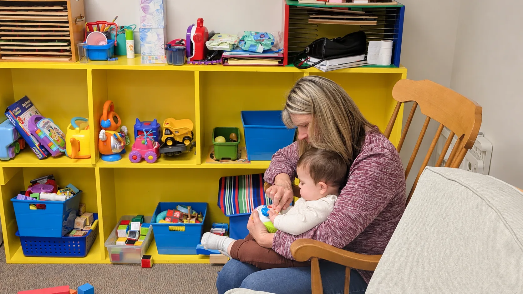 A nursery caregiver holding a baby at Rawls Baptist Church.