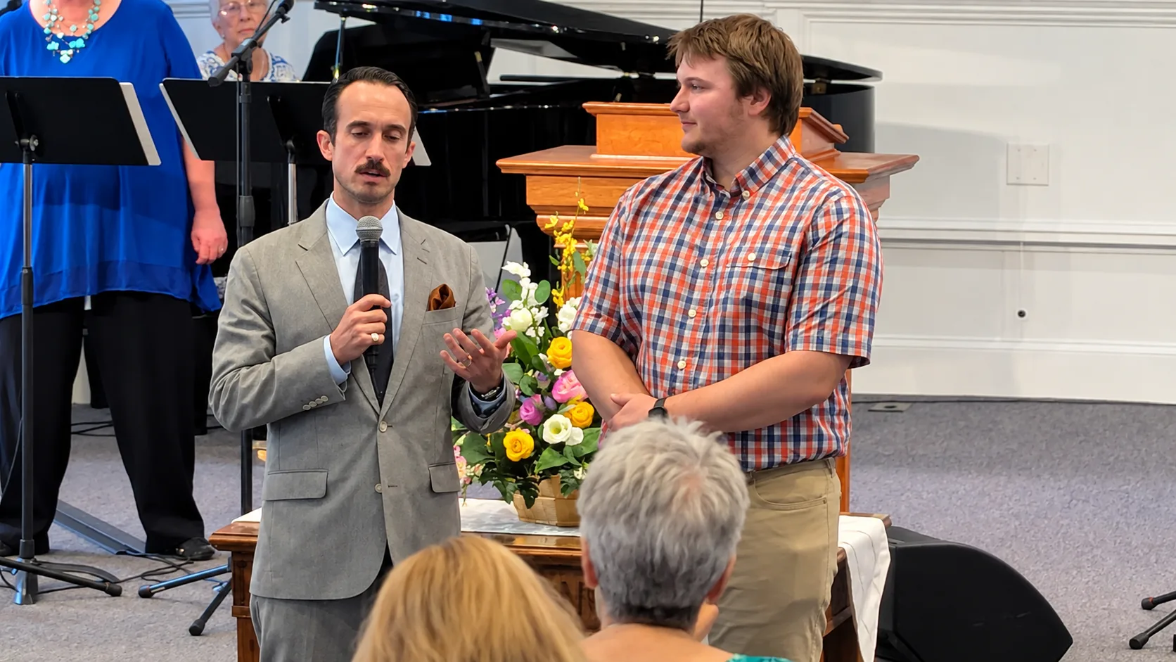 A new member standing before the Rawls Baptist Church congregation during a church membership vote.